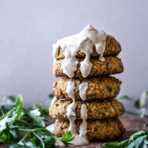 falafels stack one on top of another drizzled with tahini sauce
