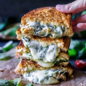 grilled cheese sandwiches with spinach cut in half
