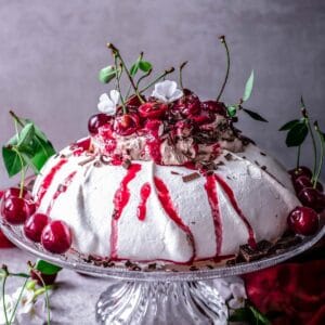 gluten-free pavlova with chocolate whipped cream and cherries