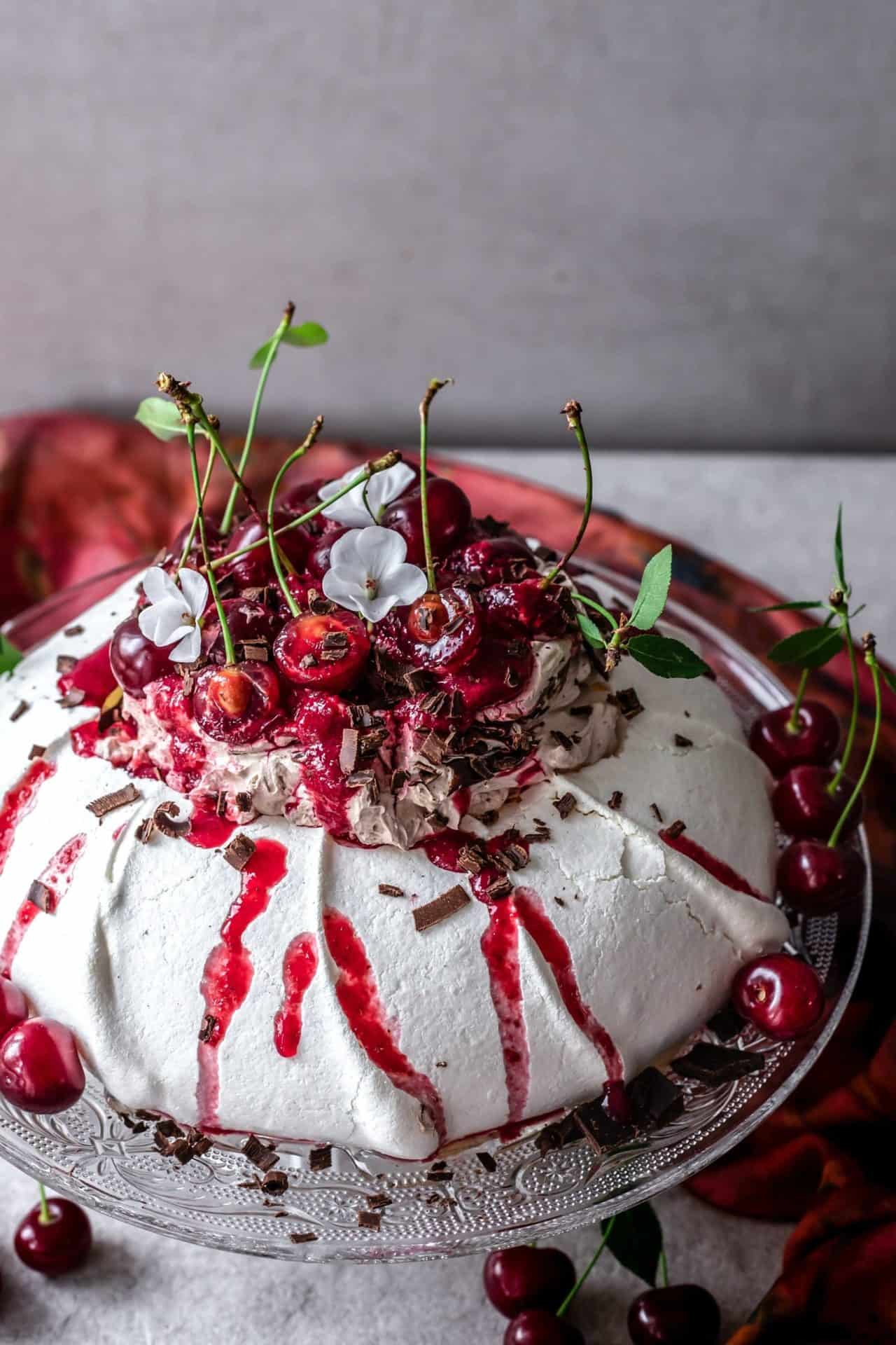 This Black Forest Pavlova is crunchy on the top, soft and marshmallowy in the middle, perfectly sweetened, chocolaty, cherry-infused and so delicious.