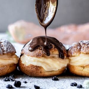 Gluten-Free Profiteroles drizzled with chocolate sauce