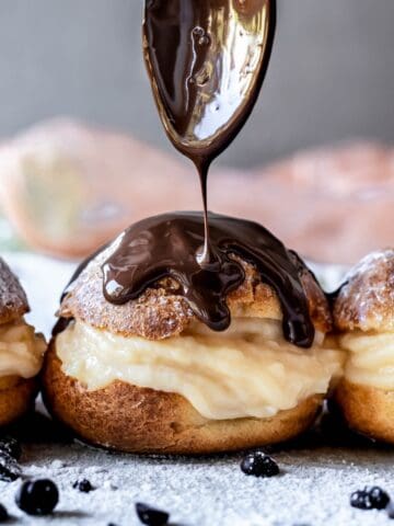 Gluten-Free Profiteroles drizzled with chocolate sauce