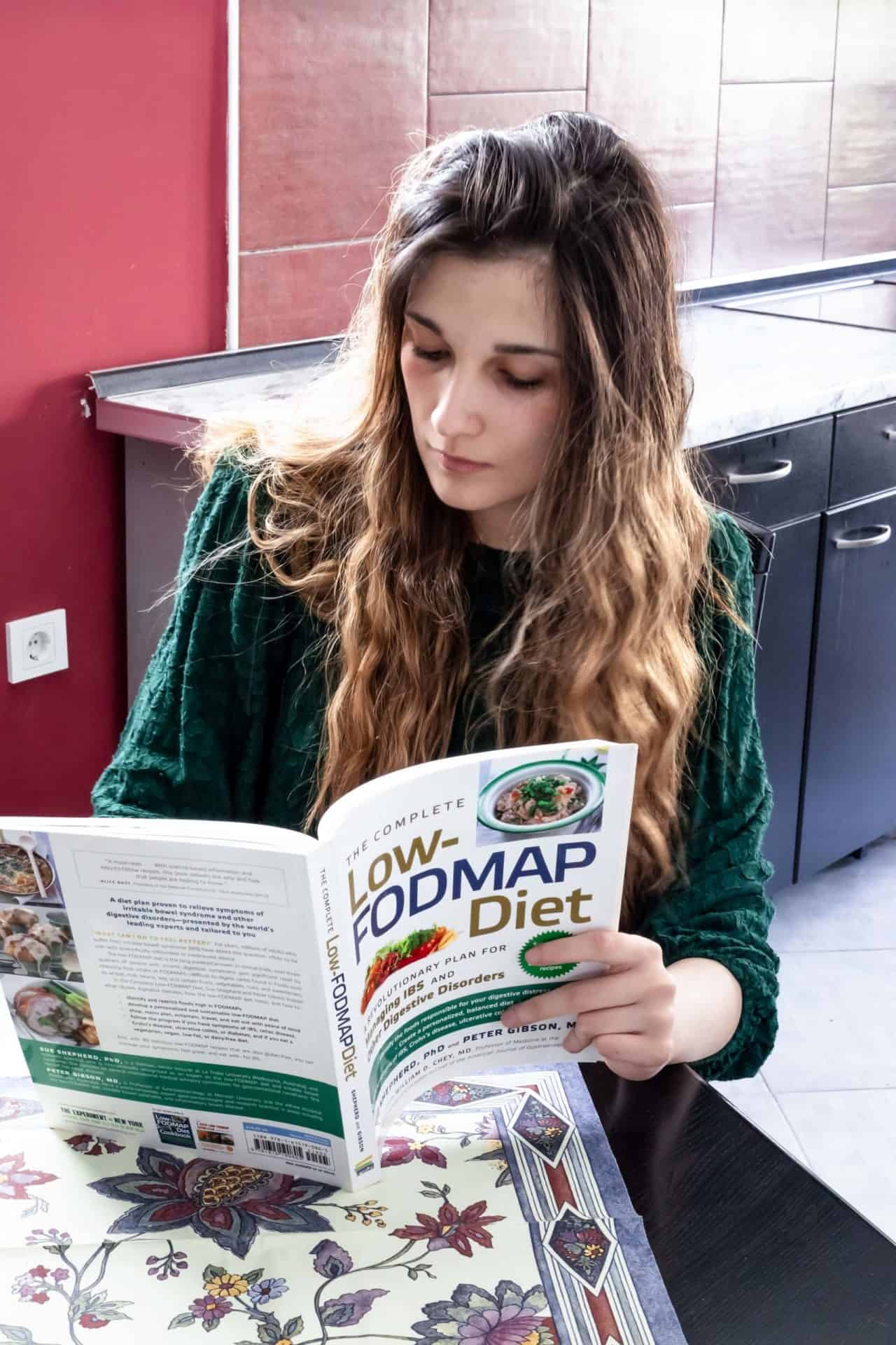 Me reading one of the low FODMAP cookbooks.