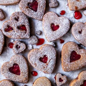 Heart shaped gluten-free linzer cookies dusted with powder sugar
