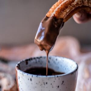 Gluten-free churro dipped in hot chocolate