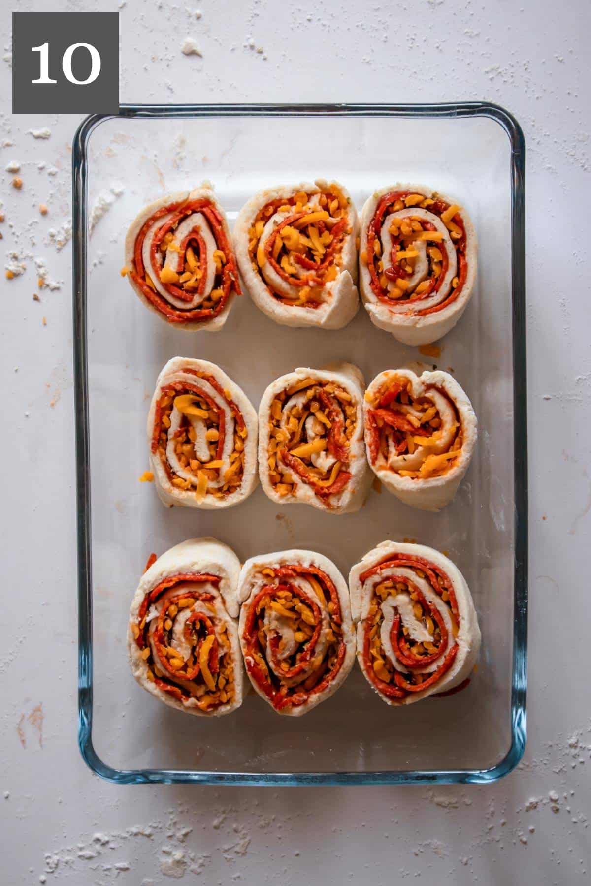 Pizza rolls in a baking dish, ready to be baked.