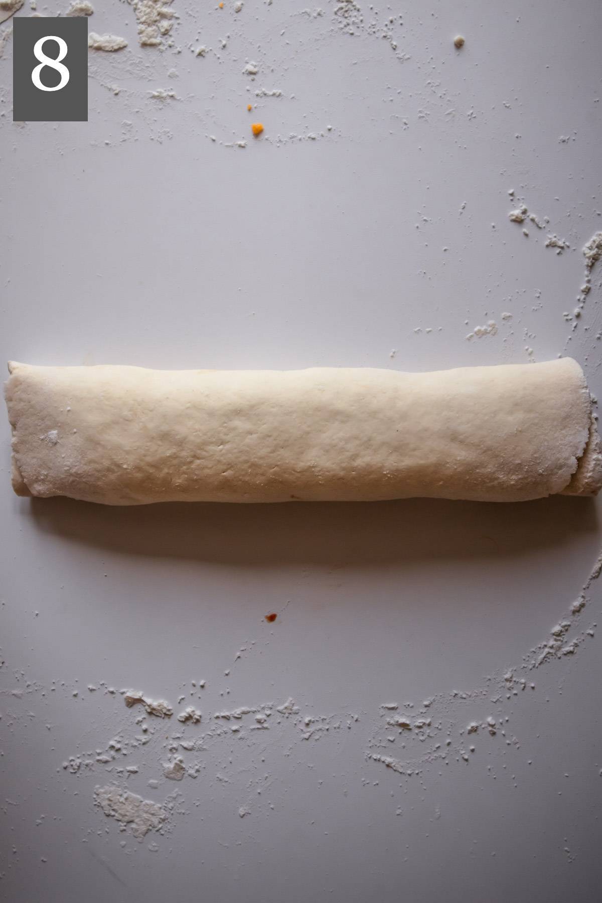The pizza dough rolled into a log.