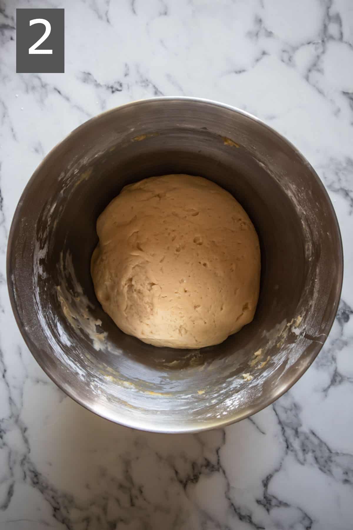 Brioche dough in a mixing bowl.