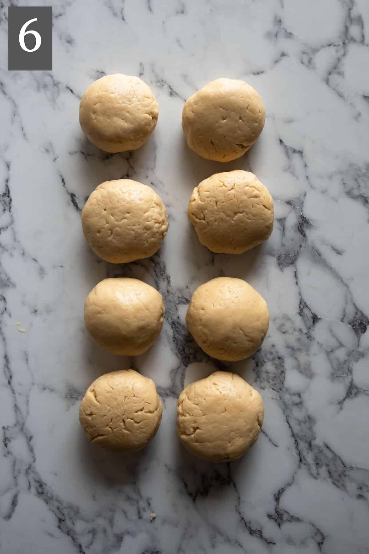 The dough divided into 8 equal portions and each shaped into a ball.