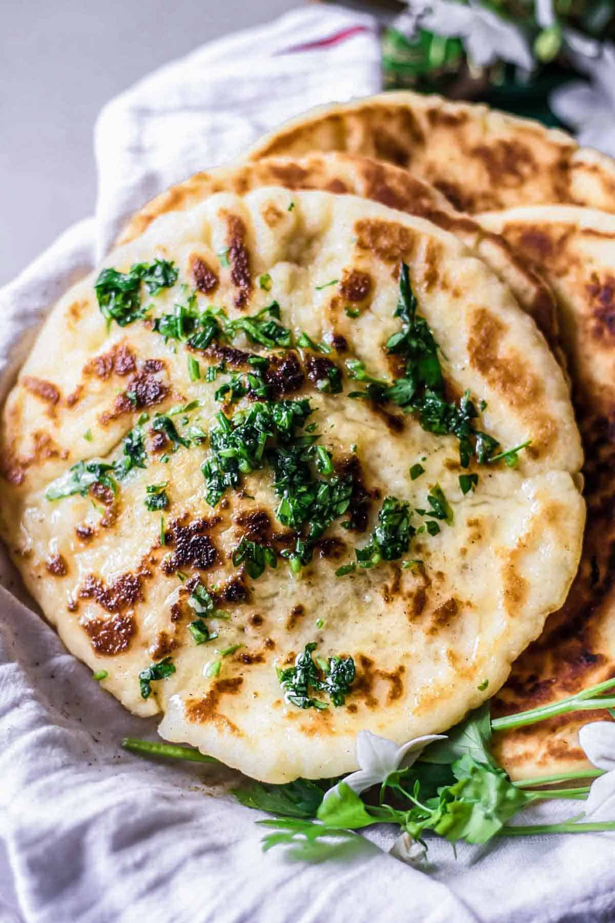 Warm gluten-free naan bread with garlic butter.