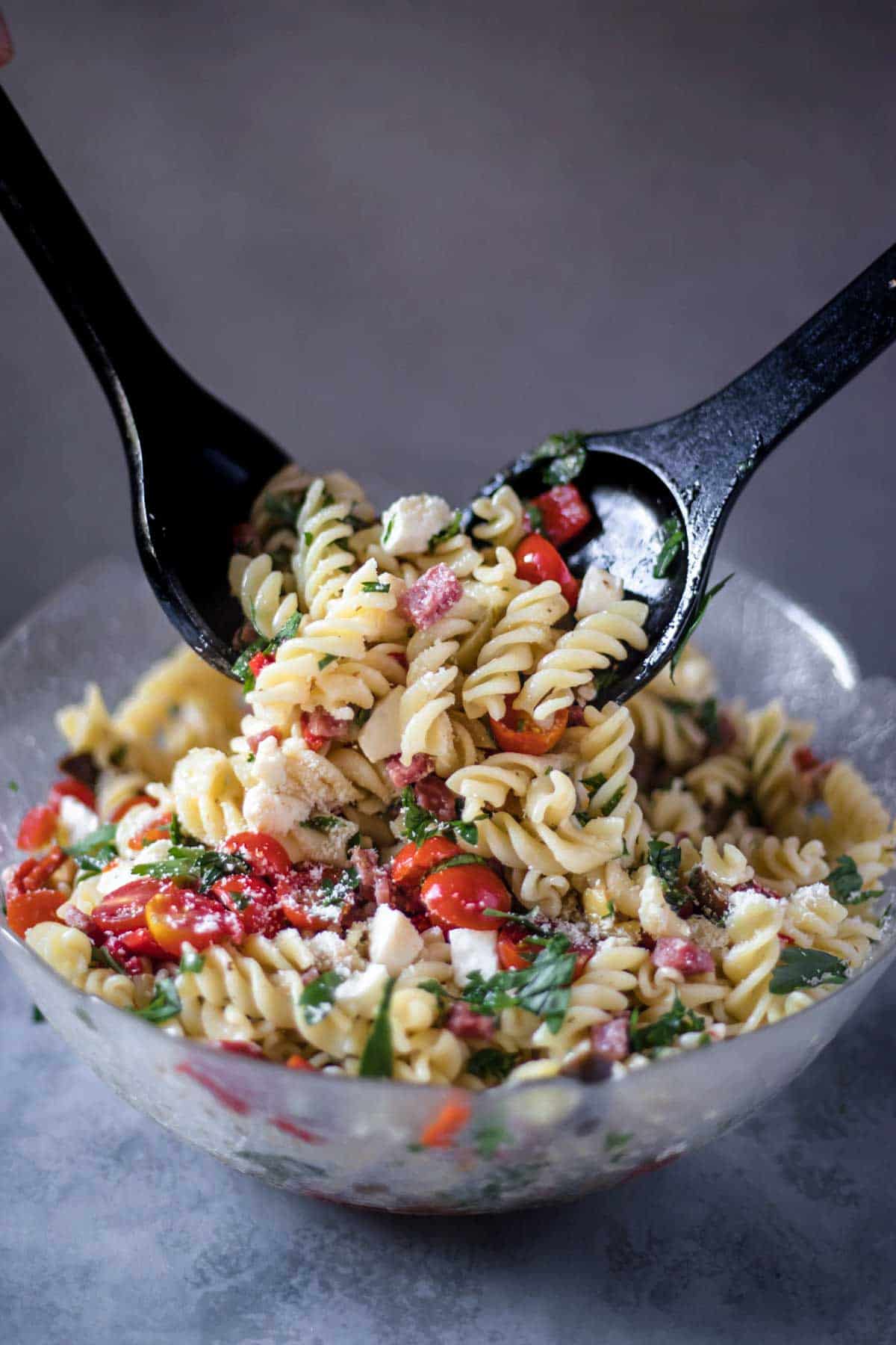 Tossing a pasta salad.