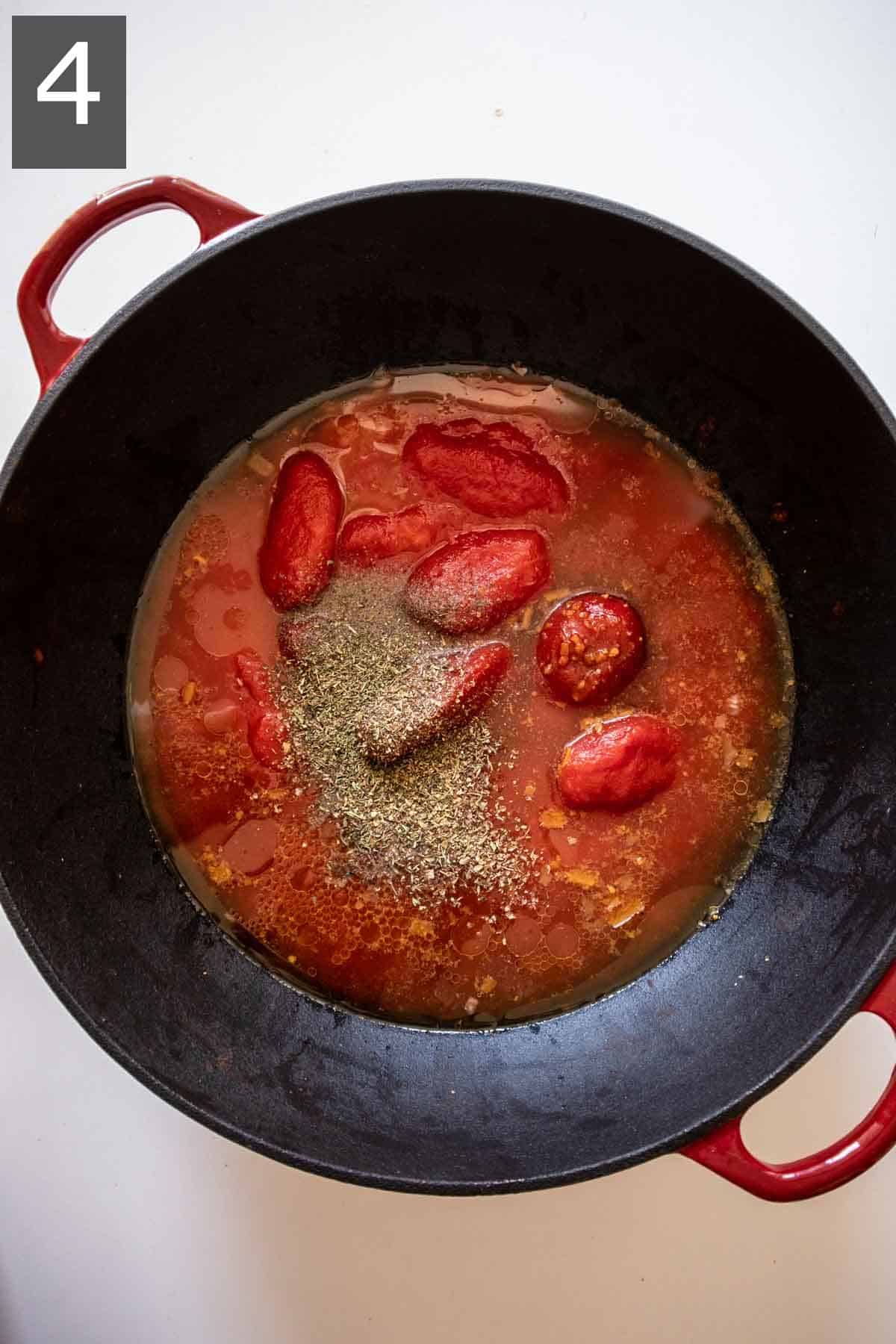 Cooking gluten-free tomato soup. Onion, garlic, plum tomatoes, vegetable broth and basil in a Dutch oven.