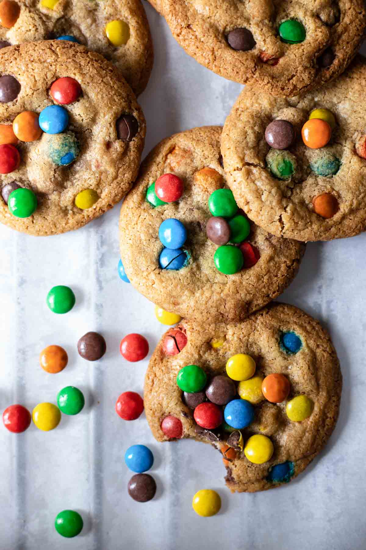 gluten-free m&m cookies on a white backdrop.