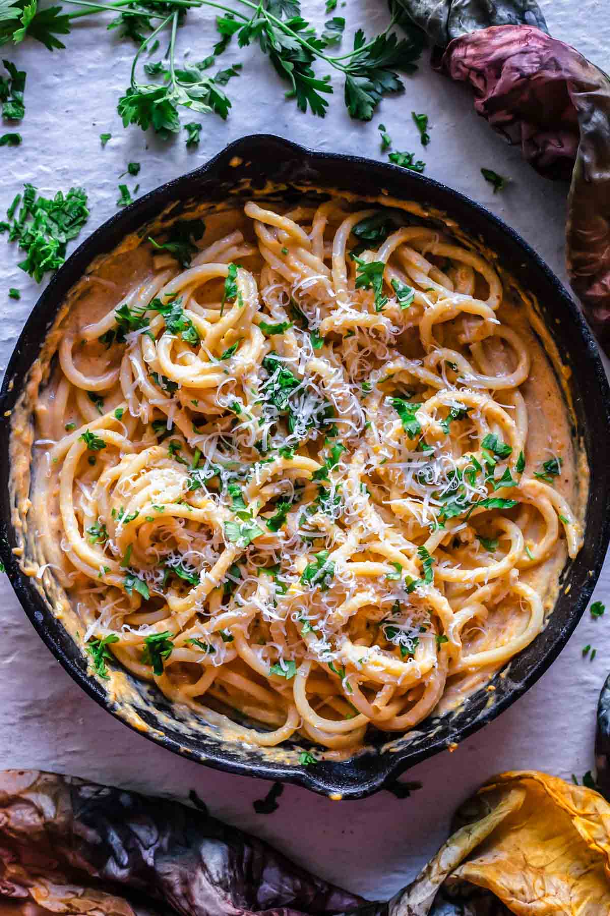 Creamy pumpkin pasta sauce served with spaghetti in a dutch oven pan