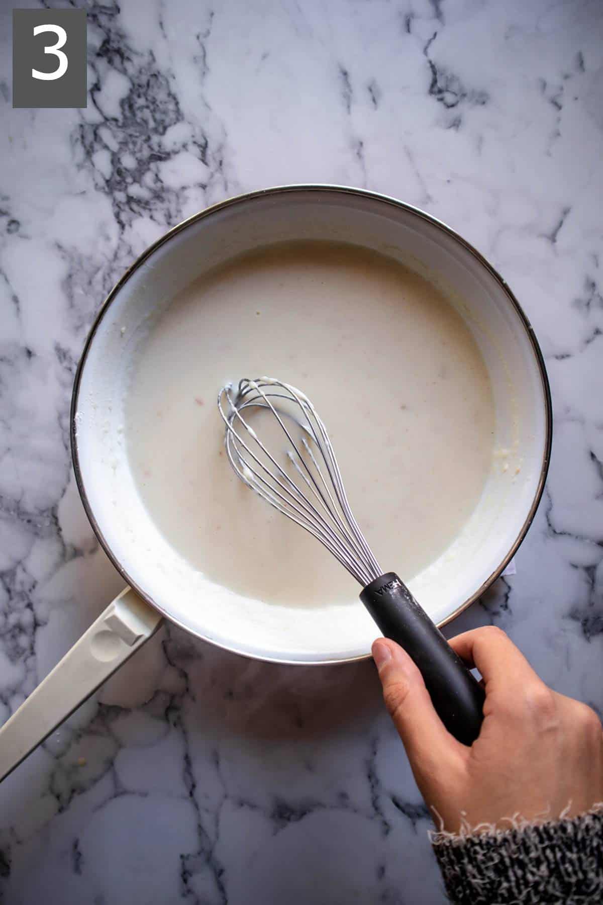 Adding milk to butter and flour mixture