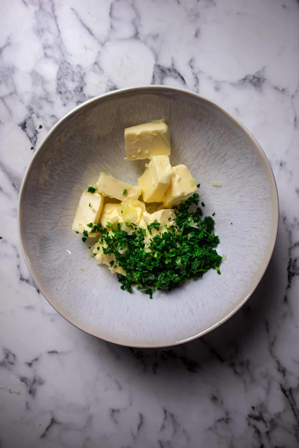 Butter, parsley and garlic in a bowl