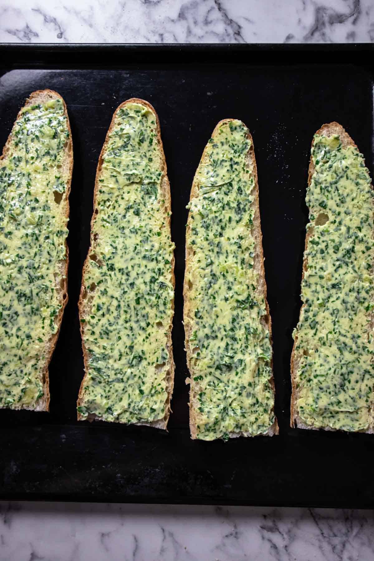 Gluten free baguette slices with a layer of garlic butter