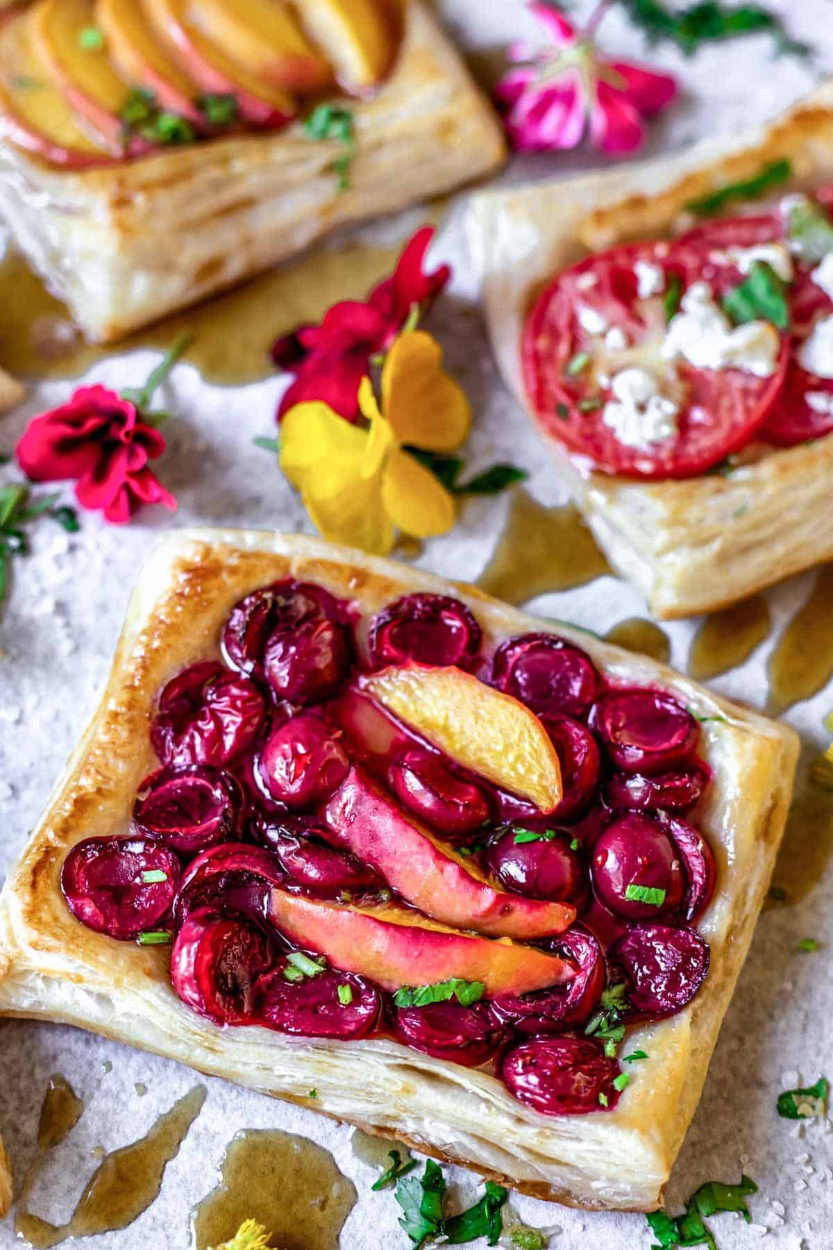 Flaky gluten free pastry topped with cherries and peaches.