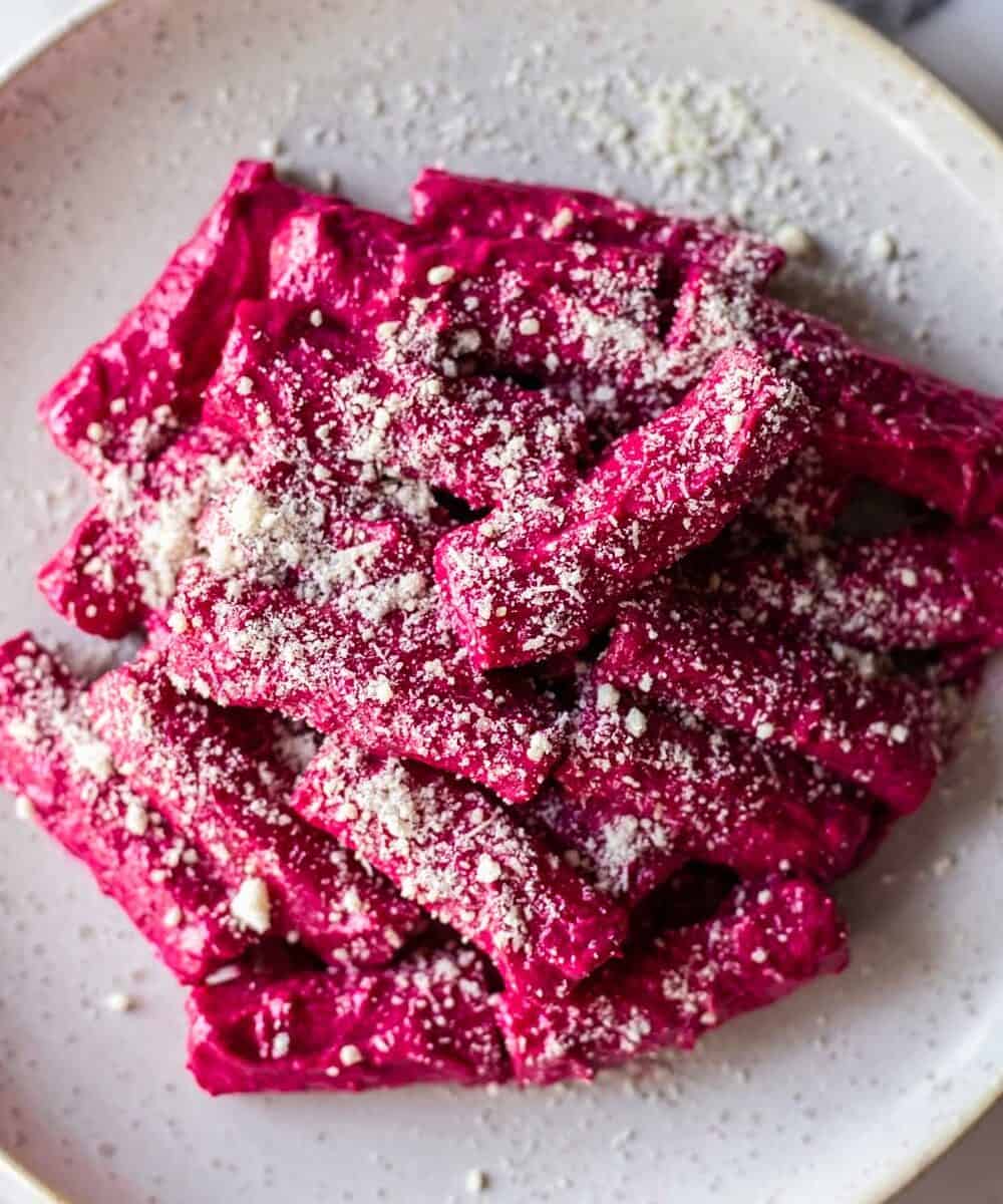 a plate of pasta with creamy beetroot sauce Cropped