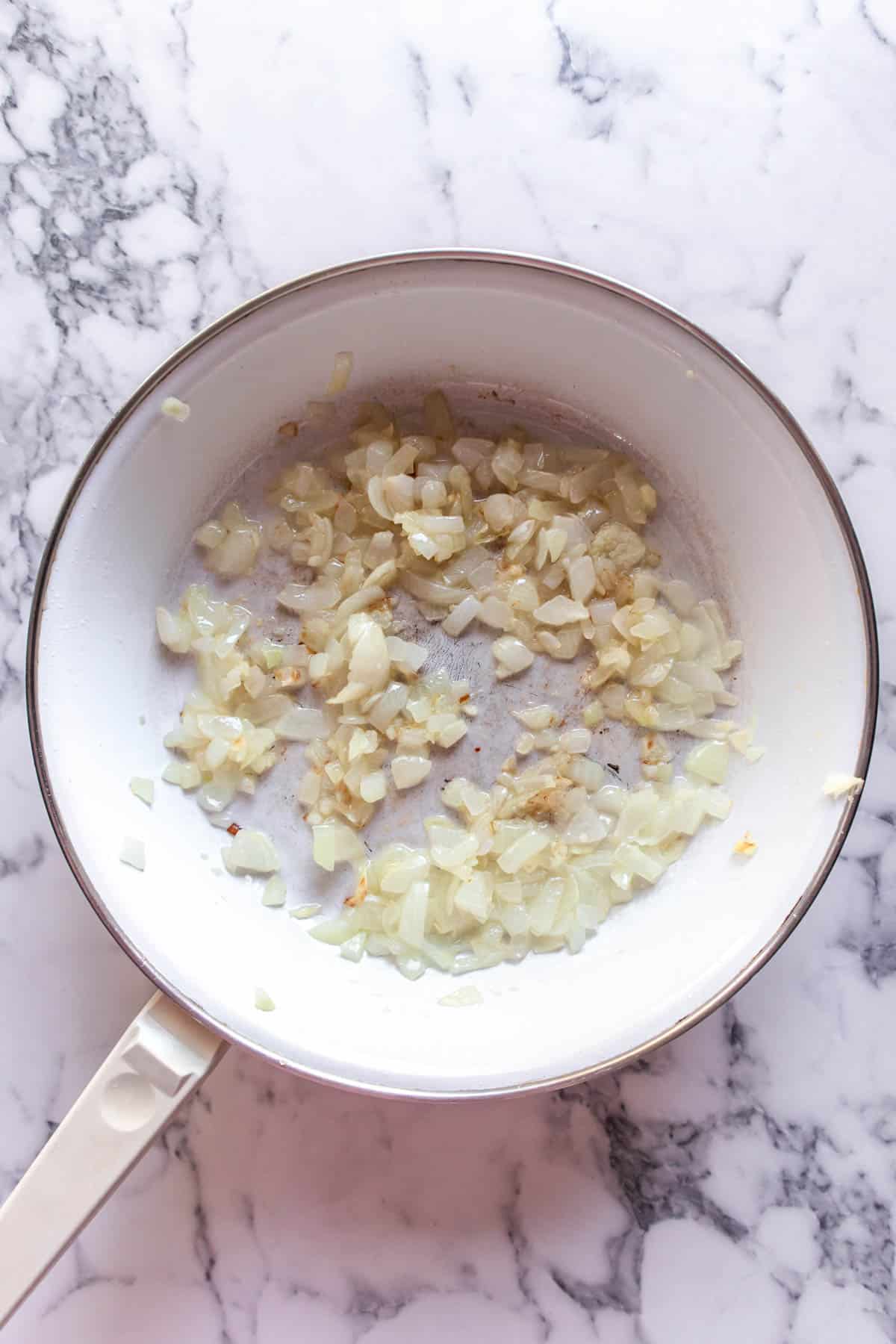 Cooking onions and garlic in a pan