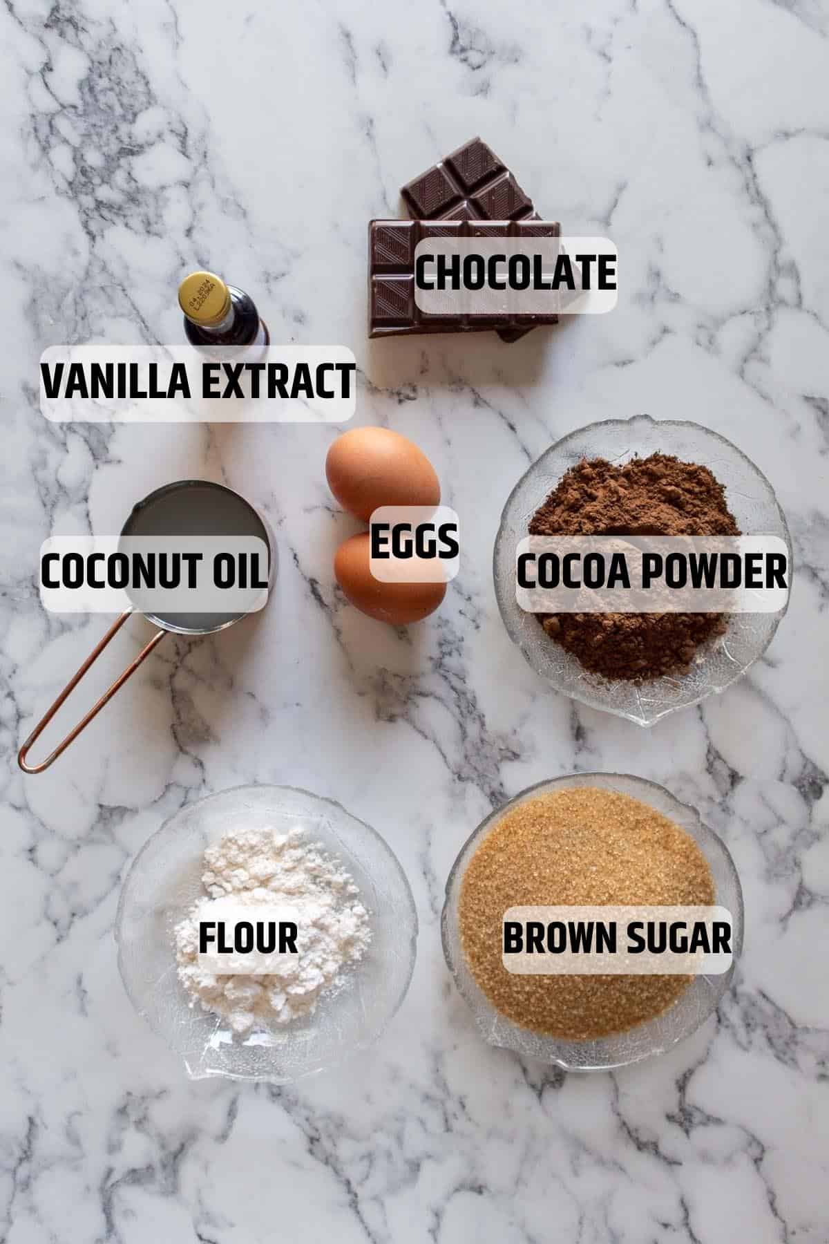 Ingredients for dairy-free brownies on a marble surface