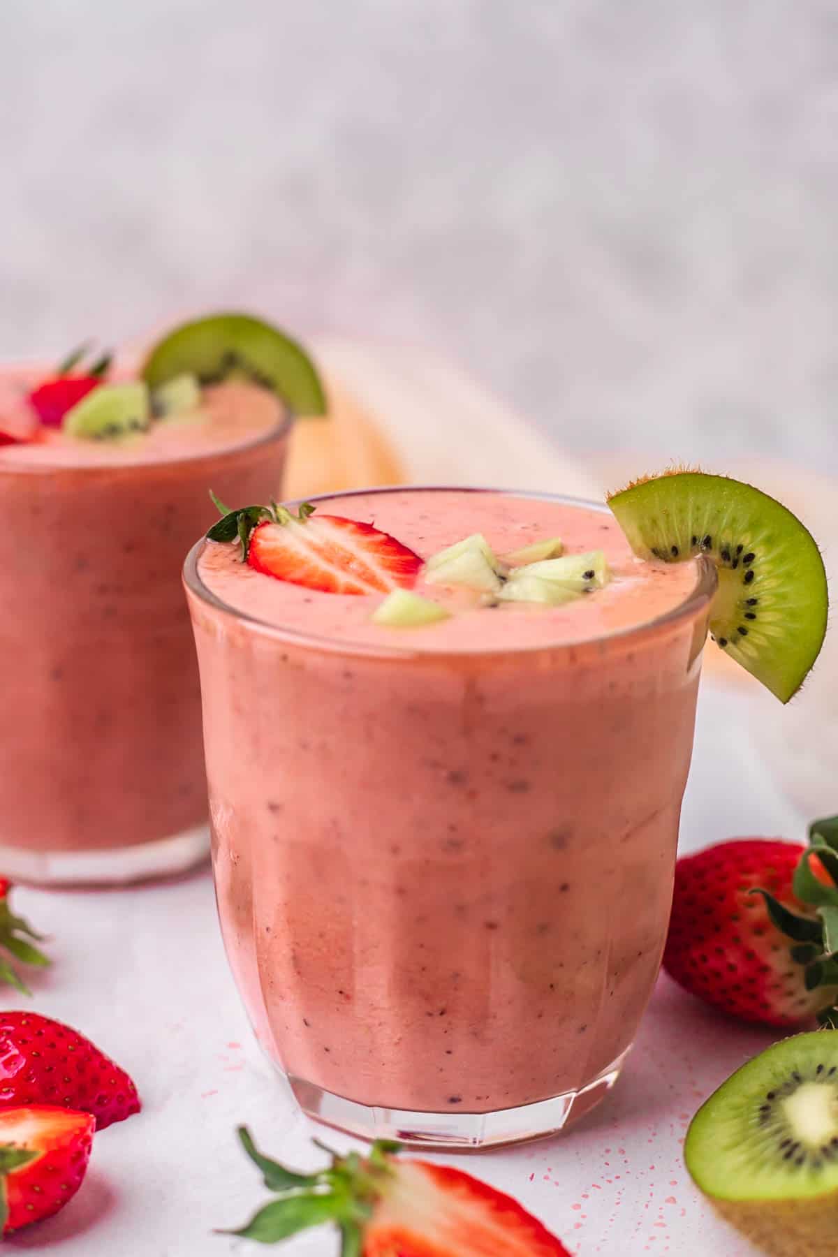 Two glasses of kiwi and strawberry smoothie
