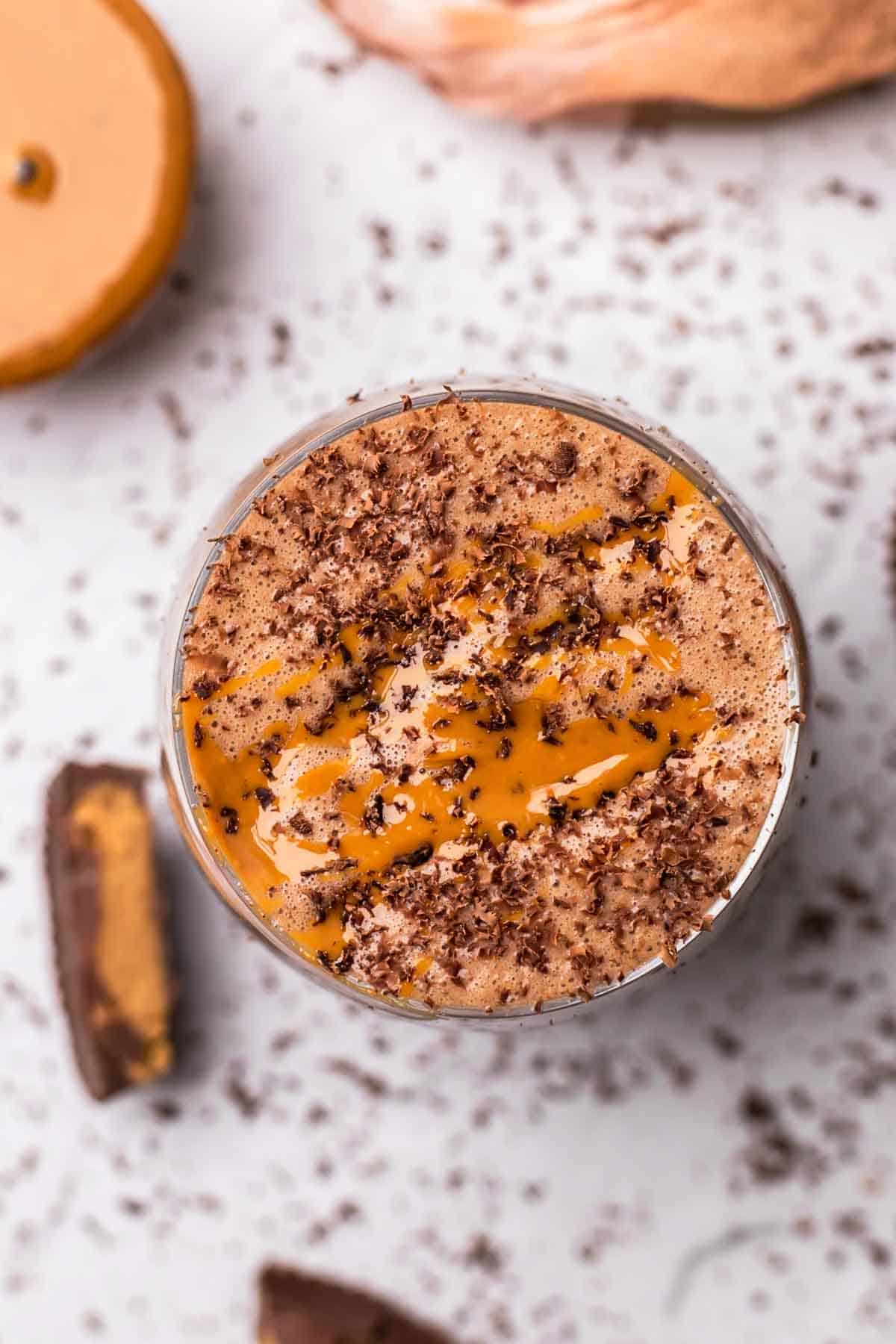 peanut butter cup smoothie in a glass photographed from above