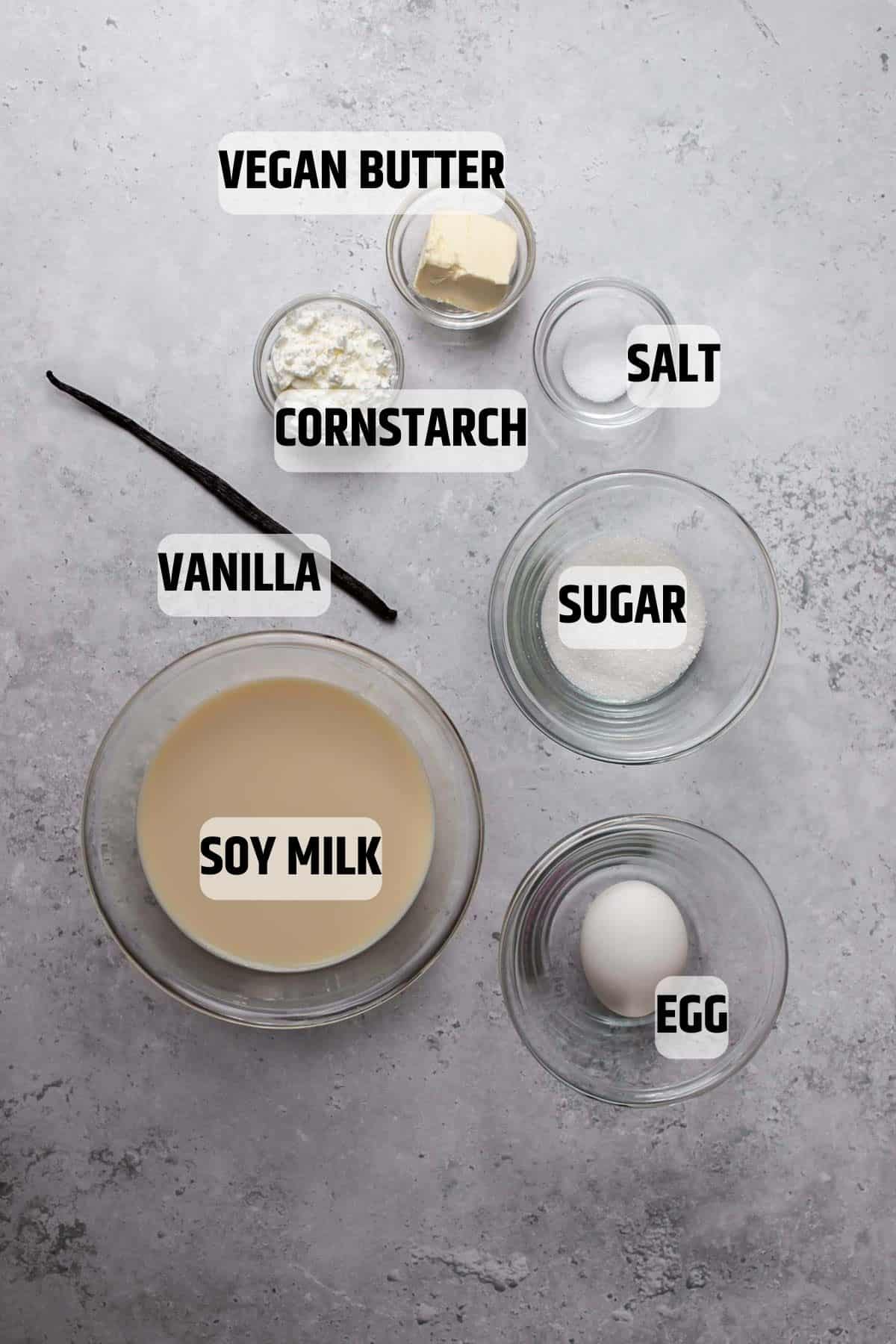 Ingredients for dairy-free custard on a Grey stone background