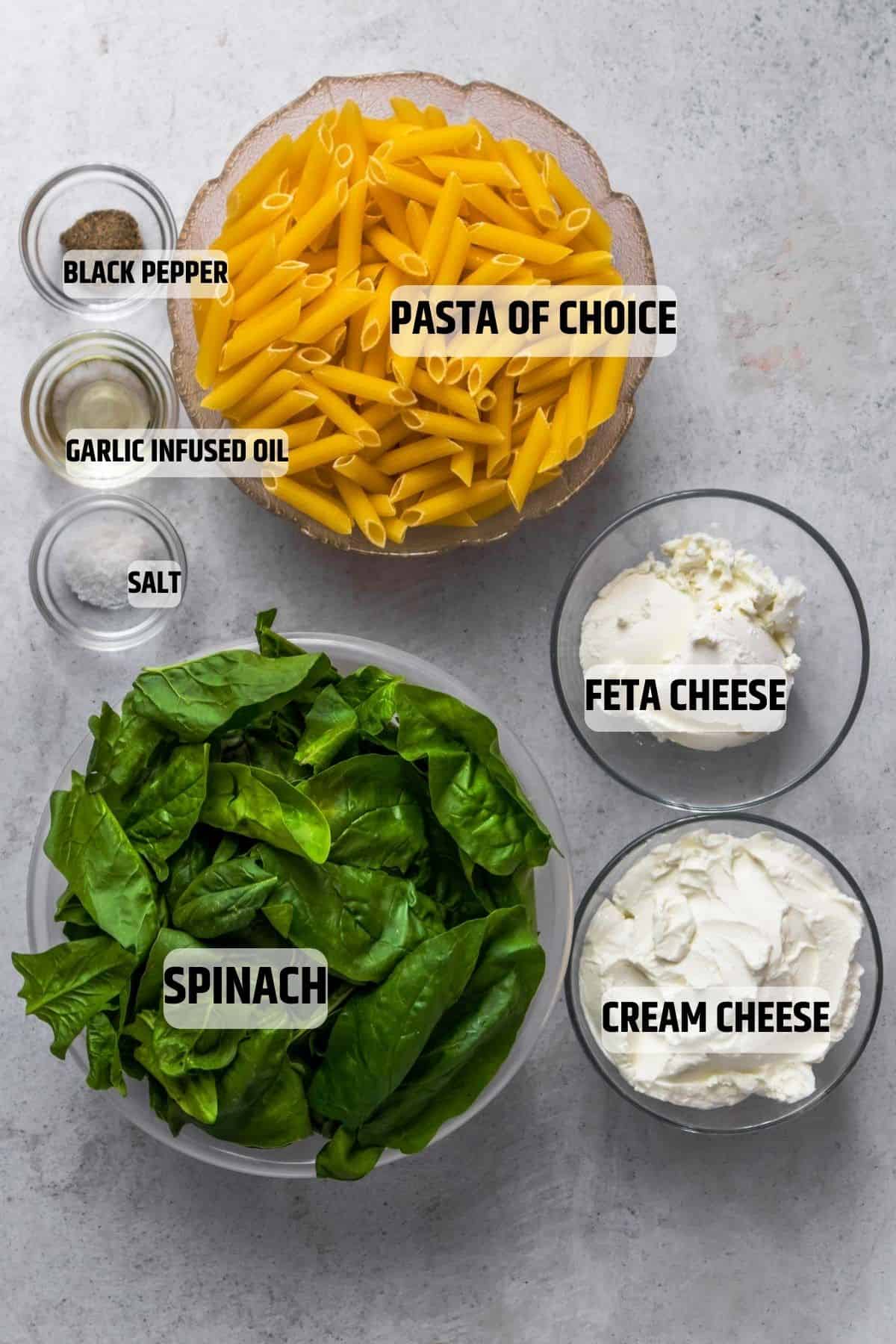 Ingredients for spinach pasta on a grey background