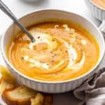 Creamy Pumpkin Soup in a bowl swirled with cream