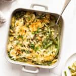 Scooping Green Bean Casserole from a casserole dish.