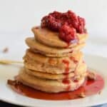 Sweet Potato Pancakes Stacked and topped with raspberry compote.