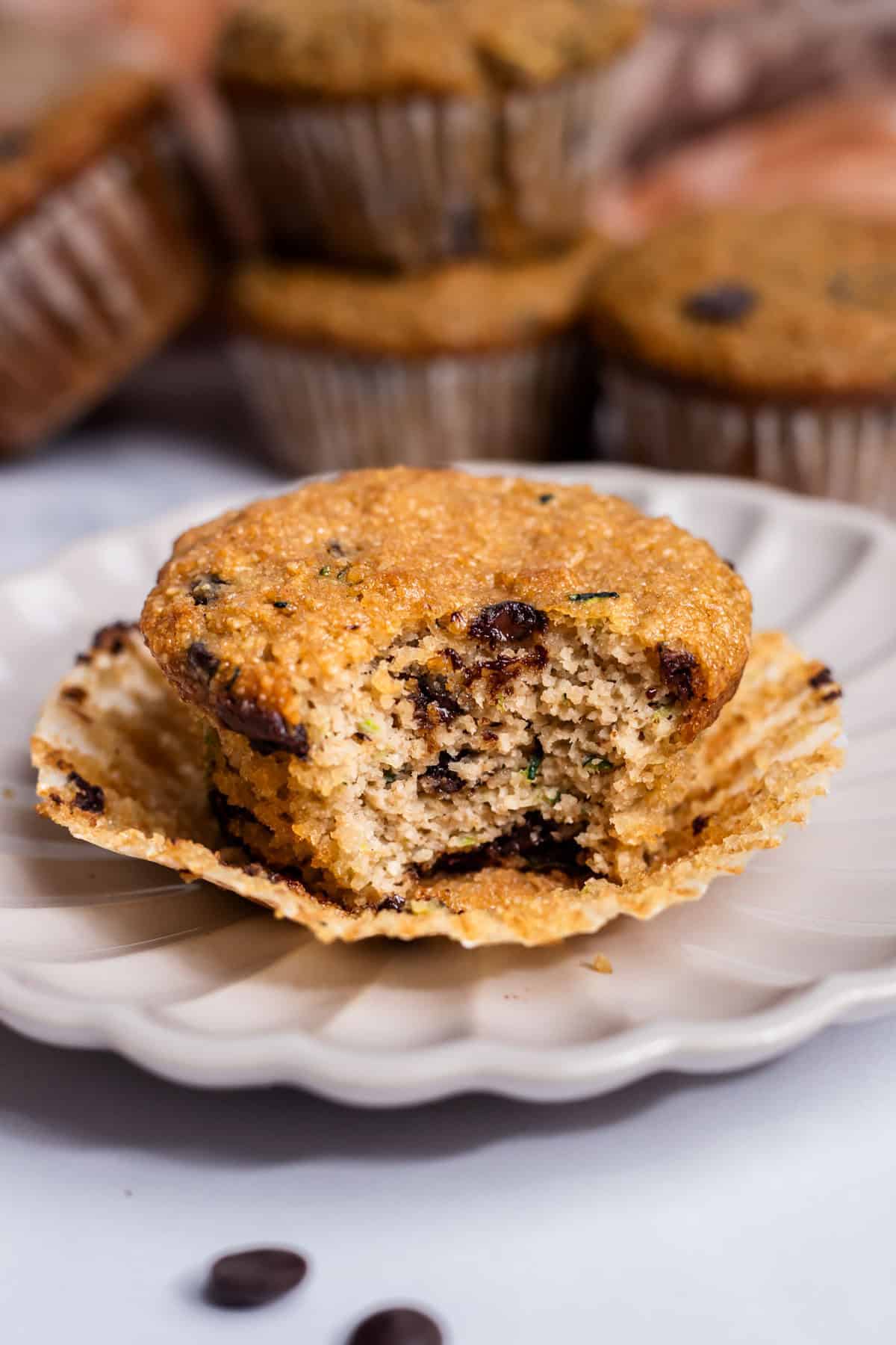 A bite of Almond Flour Zucchini Muffins showing the texture of the muffin.