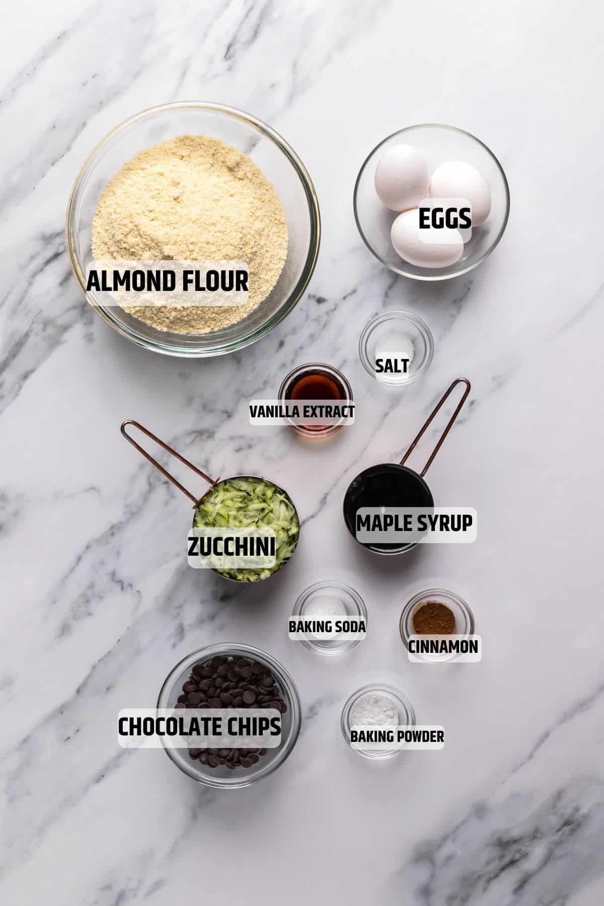 Ingredients for Almond Flour Zucchini Muffins on a marble surface
