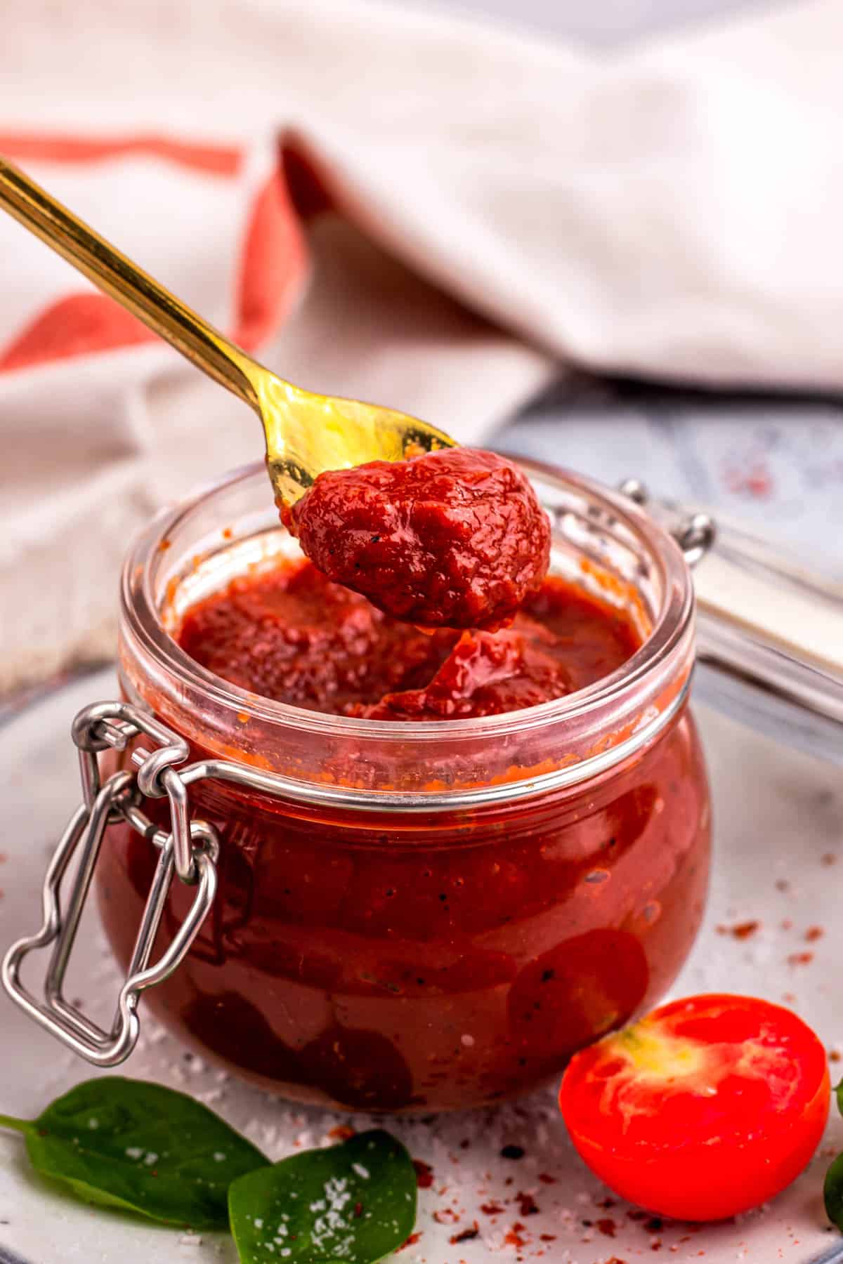 Spooning ketchup from a jar