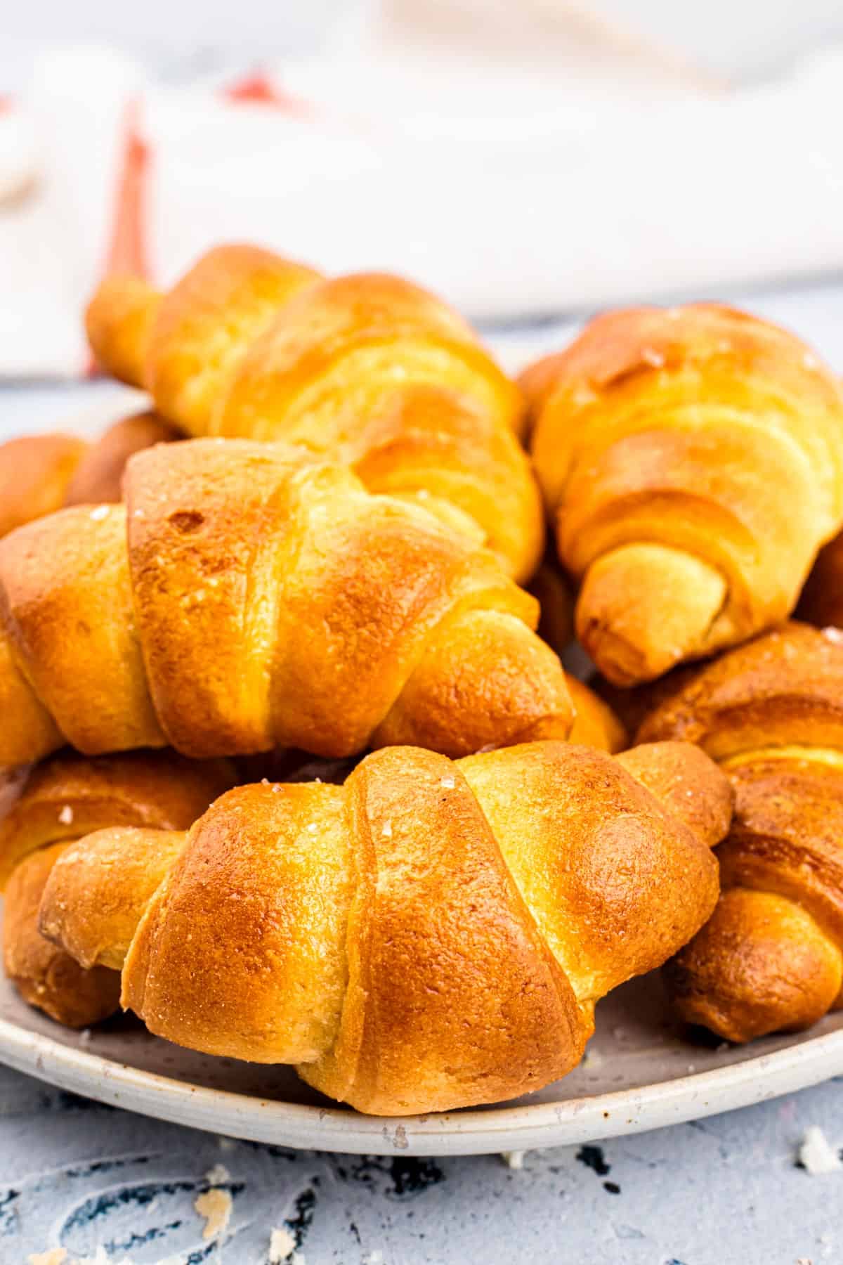 Gluten Free Crescent Rolls on a plate photographed from the side