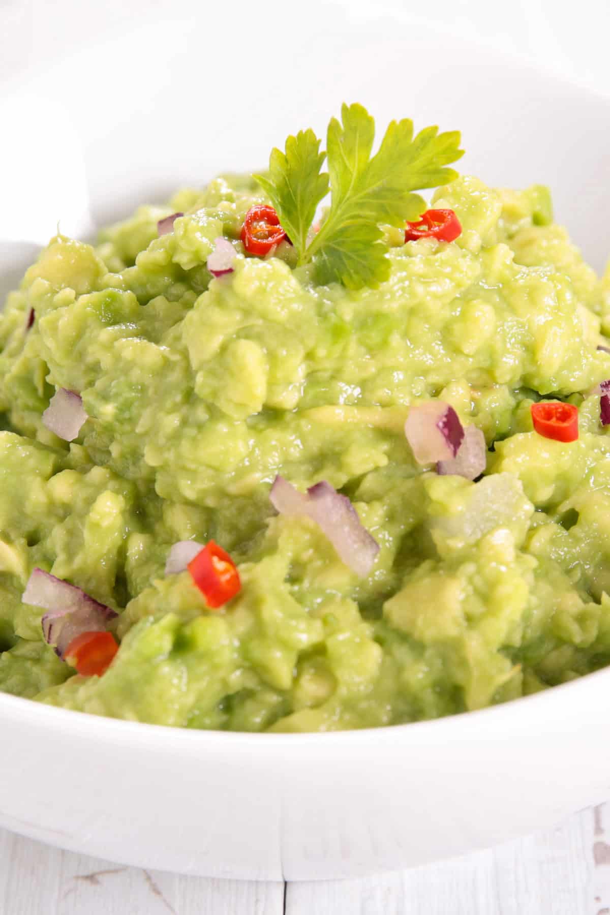 Gucamole in a small white bowl.