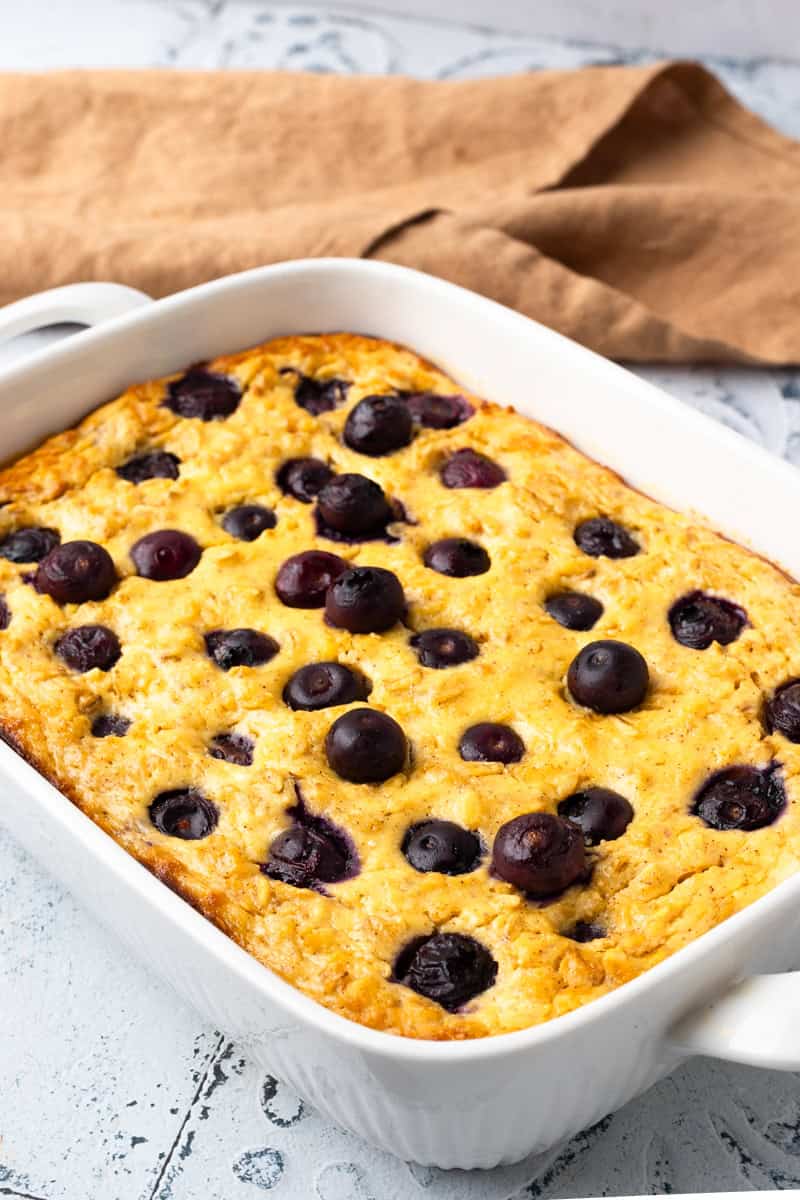 white baking dish with baked Blueberry cottage cheese breakfast bake in it