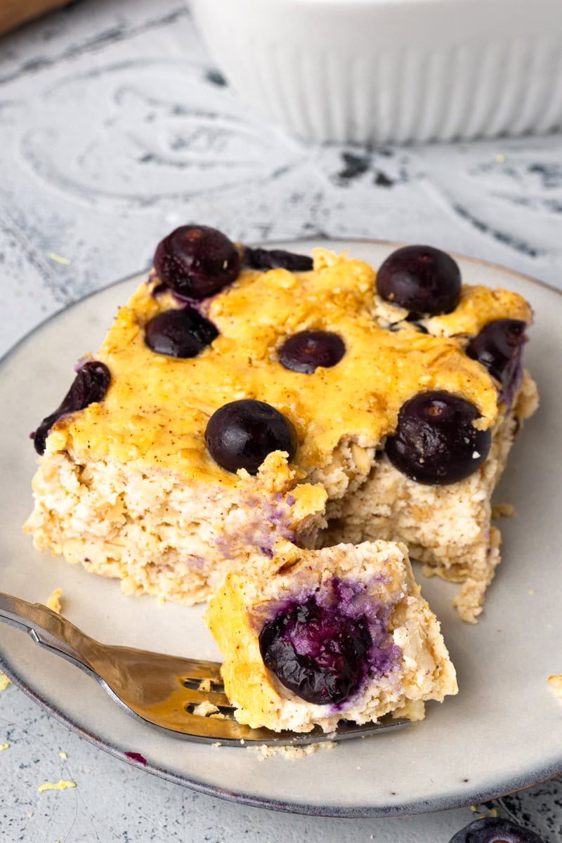 a piece of Blueberry cottage cheese breakfast bake sitting on a white plate