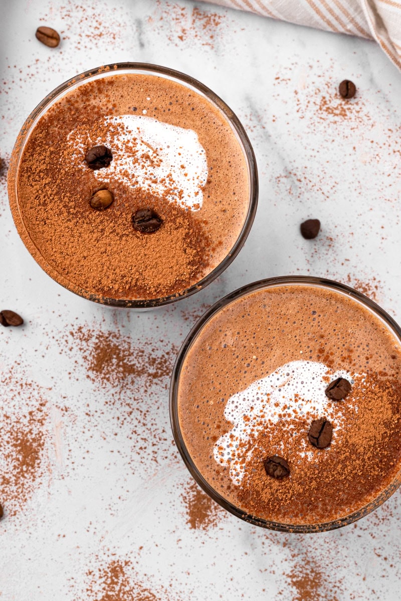 two glasses of mocha drink with cinnamon sprinkled on top