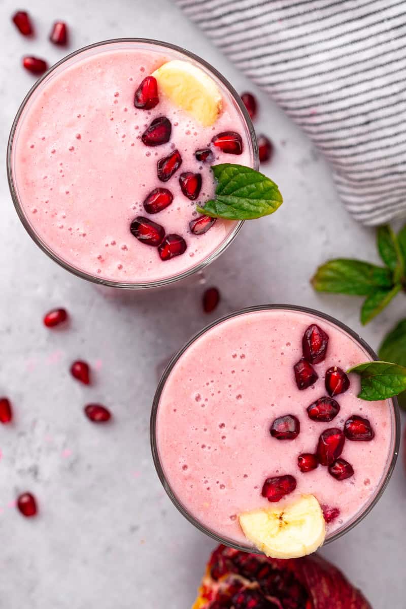 two glasses full of pomegranate smoothie mix