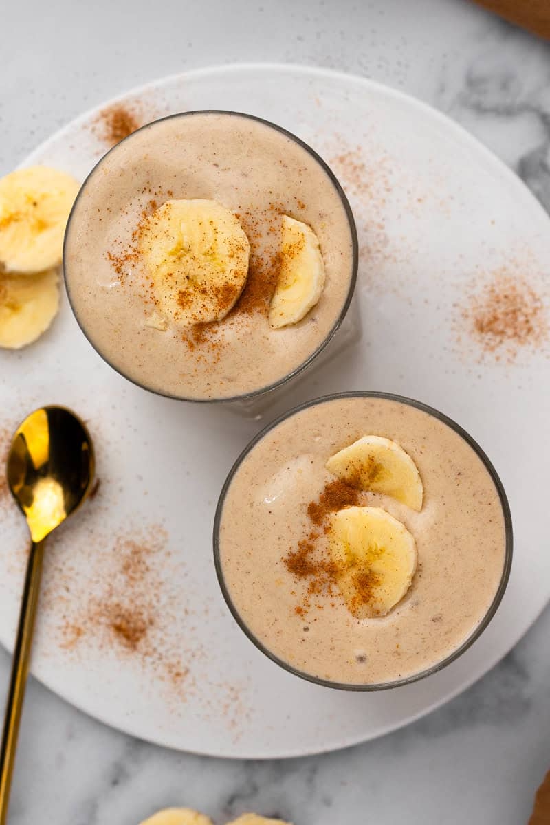 top view of banana smoothie topped with fresh bananas
