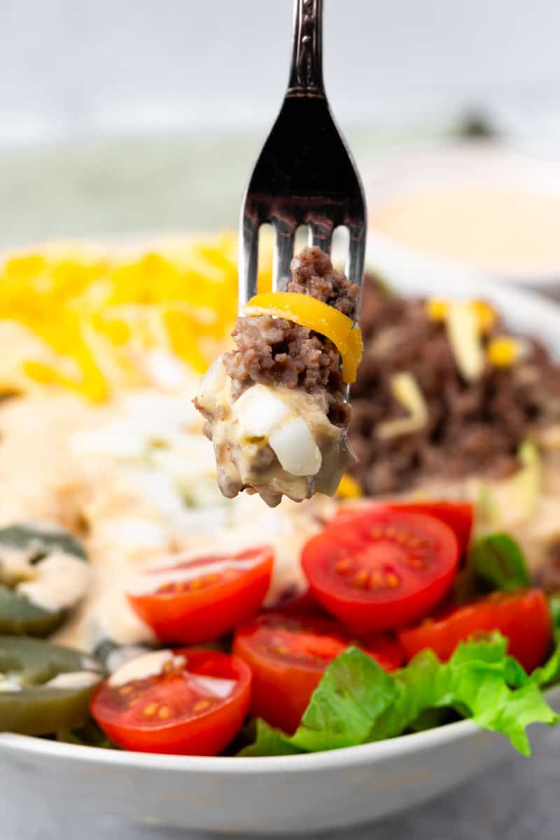 close up of fork digging into the completed cheeseburger bowl